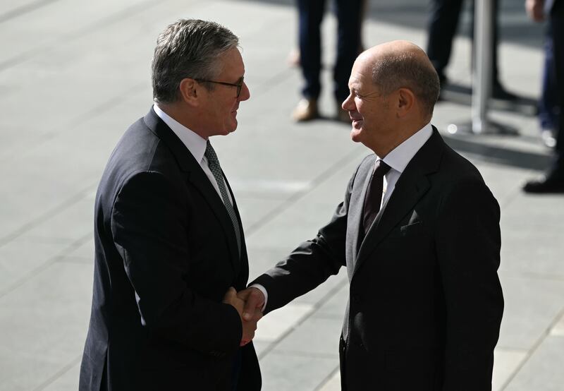 German Chancellor Olaf Scholz shakes hands with Prime Minister Keir Starmer, left, as he arrives at the Chancellery in Berlin