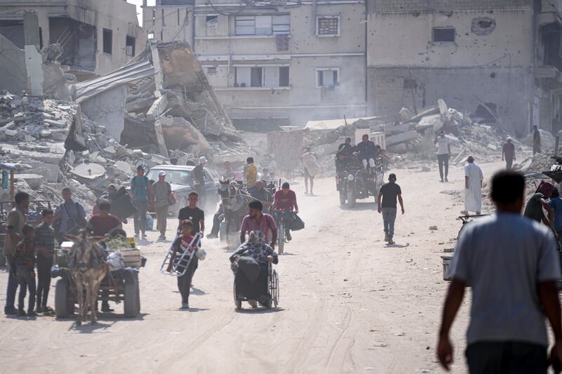 Palestinians displaced by the Israeli air and ground offensive on the Gaza Strip flee from parts of Khan Younis (Abdel Kareem Hana/AP)