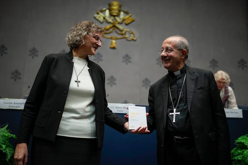 Monsignor Bruno Forte, right, and Sister Antonella Fraccaro pose for a photo with a copy of Pope Francis’ encyclical (Alessandra Tarantino/AP)