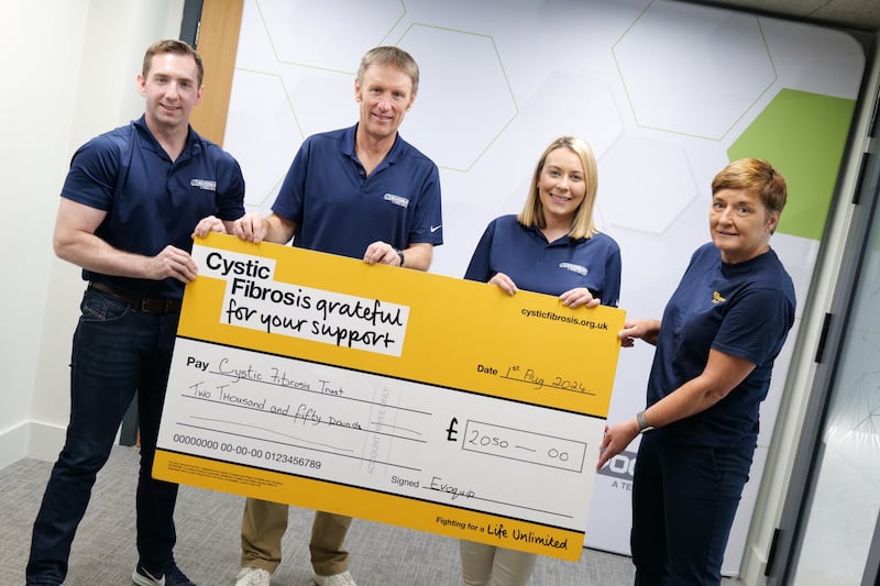 Paul O’Hagan, Andrew Cathcart, and Gemma McKelvey of Terex presenting a cheque for £2,050
to Mary McFarlane of the Cystic Fibrosis Trust, Northern Ireland.