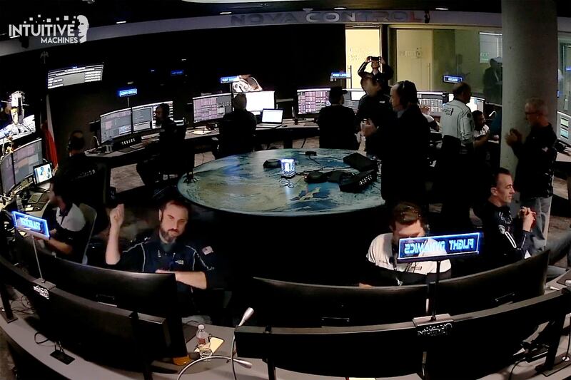 Flight controllers at Intuitive Machines in Houston reacting after its private spacecraft touched down on the Moon (Intuitive Machines/AP)