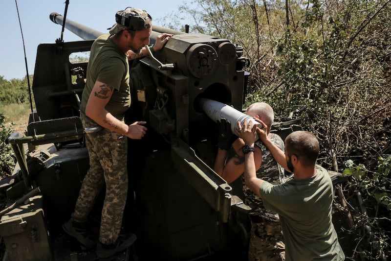 Servicemen of the 24th Mechanised Brigade fire a howitzer towards Russian positions near Chasiv Yar town, in Donetsk (Oleg Petrasiuk/Ukrainian 24th Mechanised Brigade/AP)