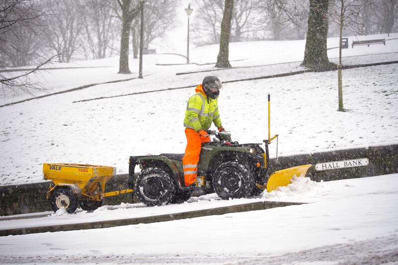 A snowplough clears a path in Buxton, Peak District