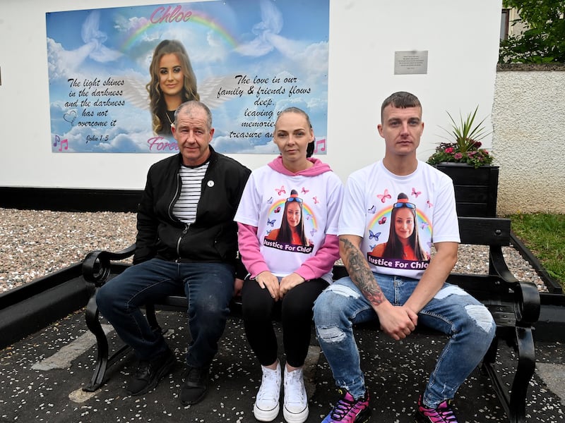 PACEMAKER BELFAST  03/06/2024
Chloe Mitchells family unveil a mural in her memory on the first anniversary of her death in Ballymena on Monday Evening.
Chloe Mitchell's father George, sister Nadine and brother Philip sit in front of the mural in Harryville.