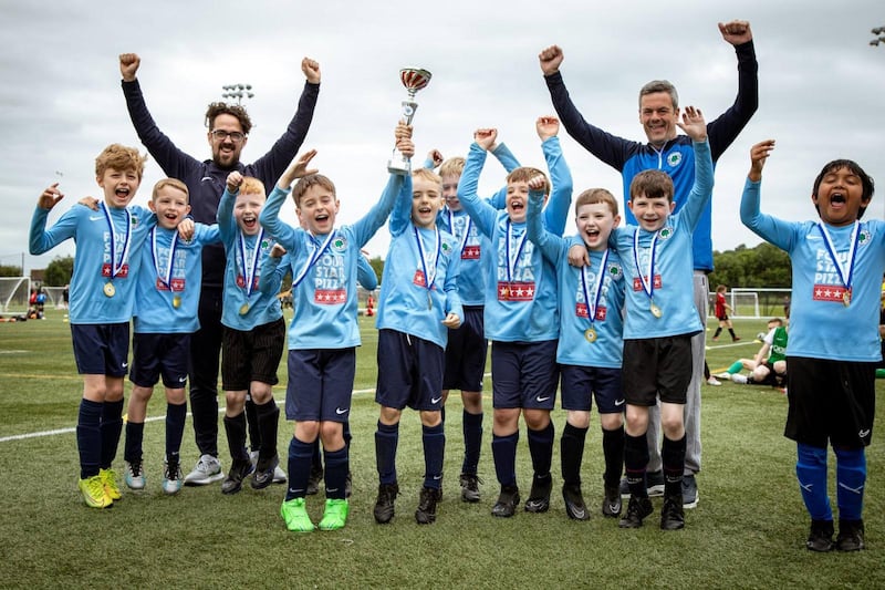 Dylan, pictured with the trophy with his team-mates of St Mary's 2015 Sharks