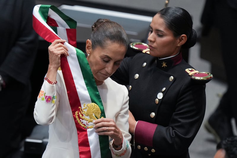 Claudia Sheinbaum puts on the presidential sash during her inauguration ceremony in Mexico City (AP Photo/Fernando Llano)