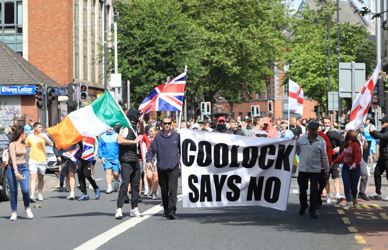 Irish and Union flags were flown side by side at the anti-immigration protest in Belfast on Saturday