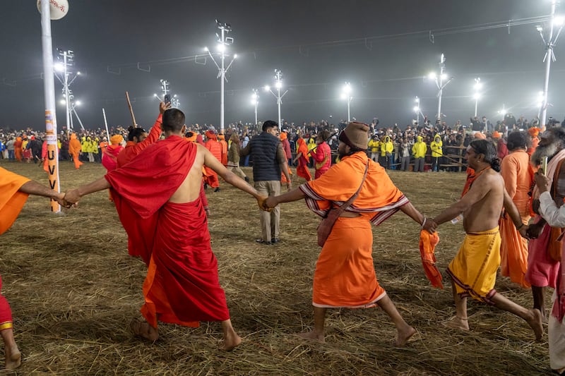 Followers line the path as Hindu holy men walk in procession to bathe at the confluence of the Ganges, the Yamuna and the mythical Saraswati rivers (Ashwini Bhatia/AP)