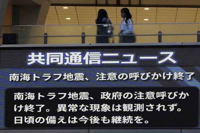 A monitor shows a message that Japan’s government announced the end of its week-long drive for increased caution and preparedness for a possible megaquake