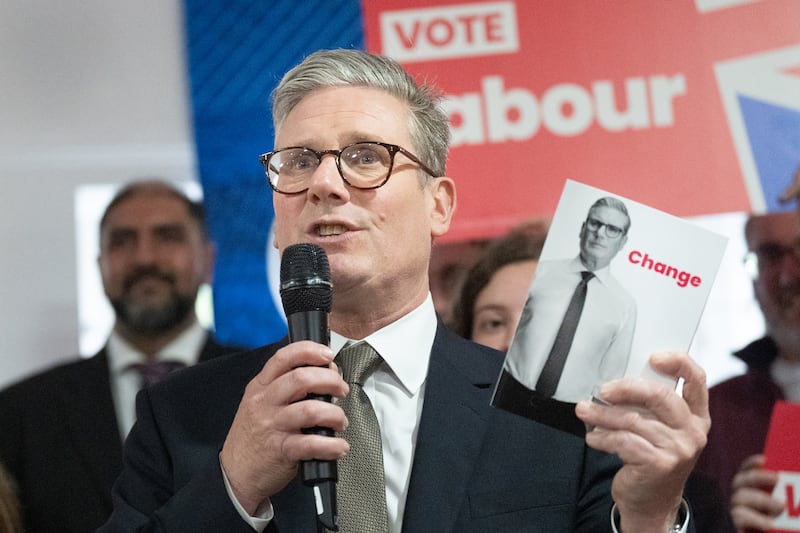 Sir Keir Starmer holds a copy of his party’s election manifesto