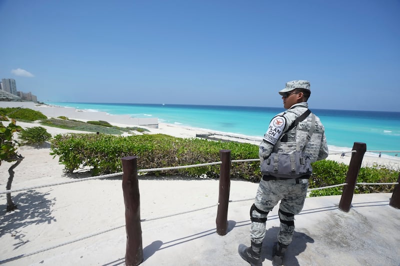 A Mexican soldier stands guard on a beach ahead of Hurricane Beryl’s expected arrival (Fernando Llano/AP)