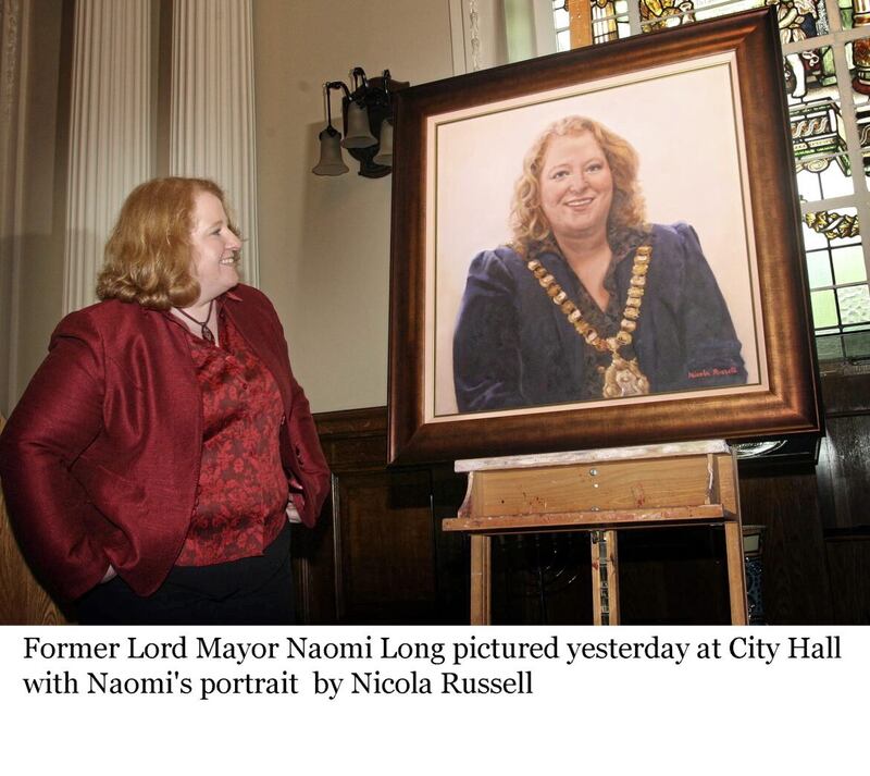 Former Lord Mayor Naomi Long pictured at City Hall with her portrait by Nicola Russell 