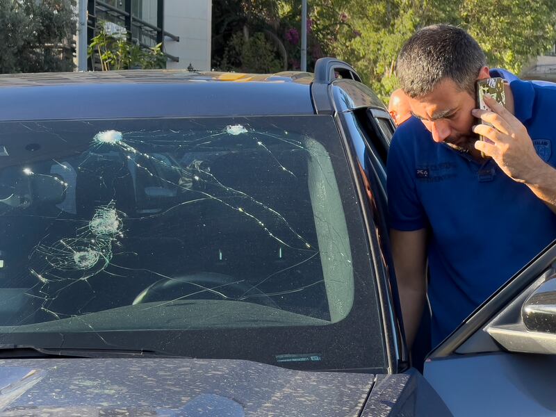 A police officer inspects a car in which a hand-held pager exploded, in Beirut, Lebanon (Hussein Malla/AP)