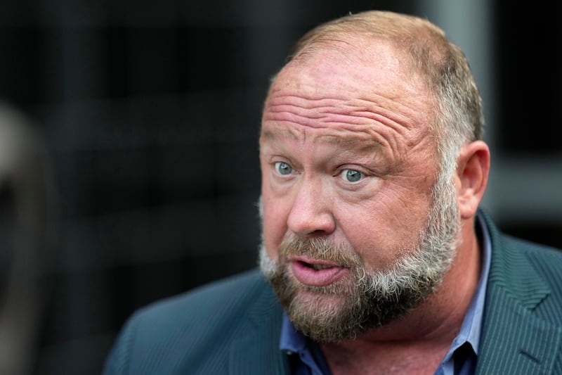 Right-wing conspiracy theorist Alex Jones had his head in his hands (David J Phillip/AP)