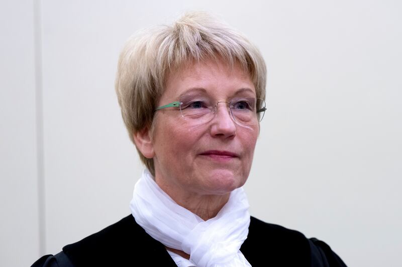 Presiding judge Dagmar Illini enters the courtroom at the Higher Regional Court in Munich ahead of the start of the trial (Sven Hoppe/dpa via AP)