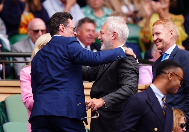 Hugh Jackman and Sir Sam Mendes in the royal box on day 13 of the 2024 Wimbledon Championships