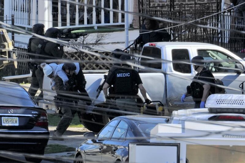 A resident being evacuated from a home in Trenton, New Jersey, on Saturday as police hunted a gunman (Matt Rourke/AP)