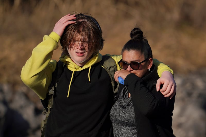 A student and a family member walk from Antioch High School after the shooting George Walker IV/AP)