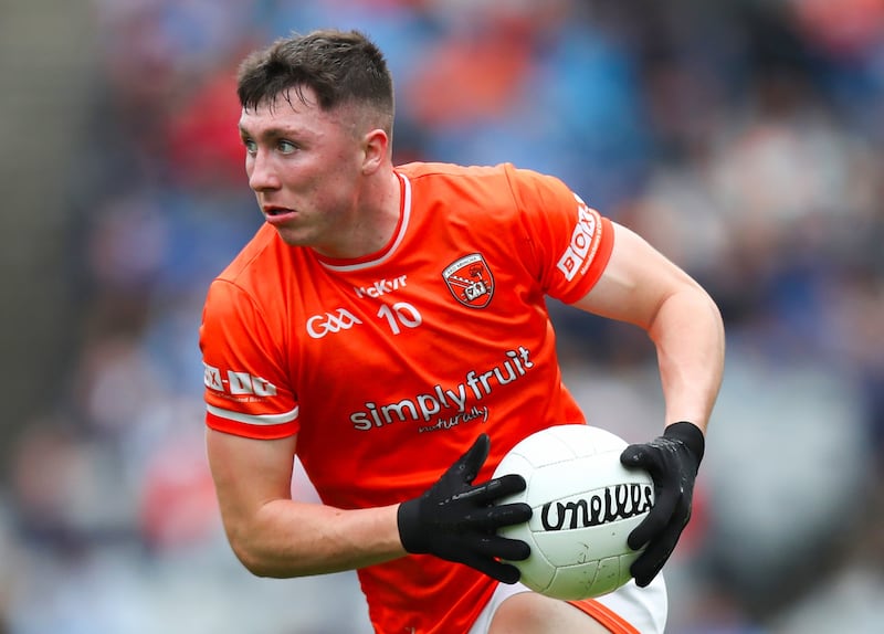 Oisin Conaty carrying a ball