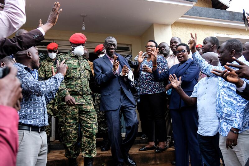 Ugandan opposition leader and four-time presidential candidate Kizza Besigye, centre left, arrives at the Makindye Martial Court in Kampala in November 2024 (Hajarah Nalwadda/AP)