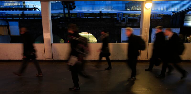 Commuters make their way into London Bridge Underground and railway stations