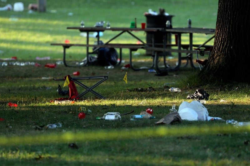 Debris is strewn around evidence markers in an area of Maplewood Park, Rochester, New York (Tina MacIntyre-Yee/AP)