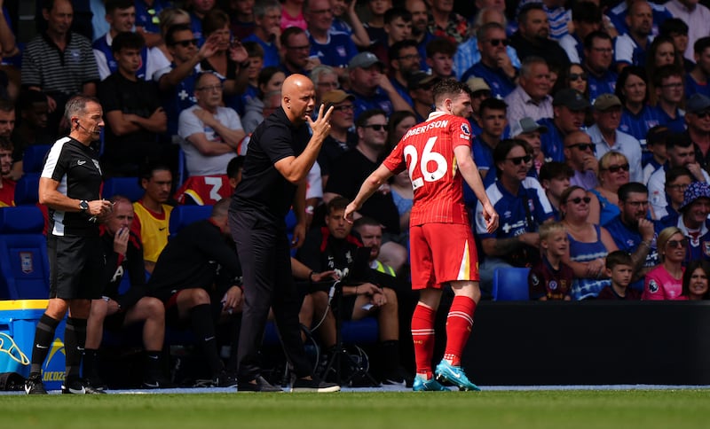 Liverpool boss Arne Slot speaks to Andrew Robertson