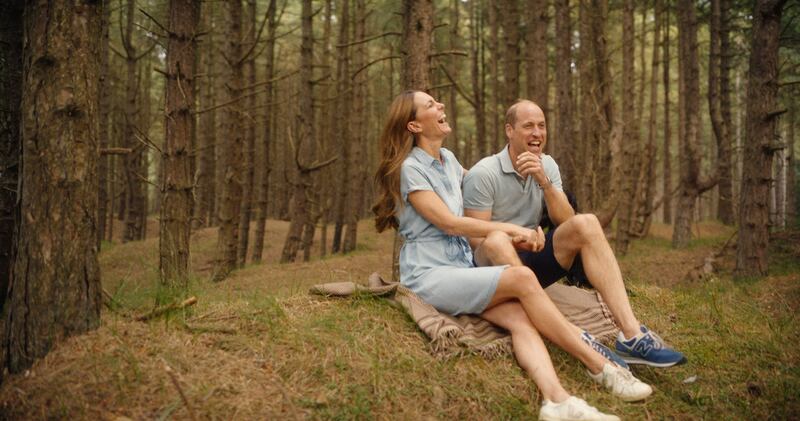 Kate and William sitting together in the woods