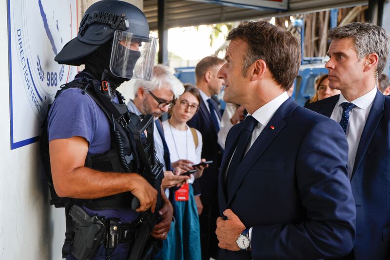 The French president thanked officers for facing what he described as ‘an absolutely unprecedented insurrection movement’ (Ludovic Marin/Pool Photo via AP)