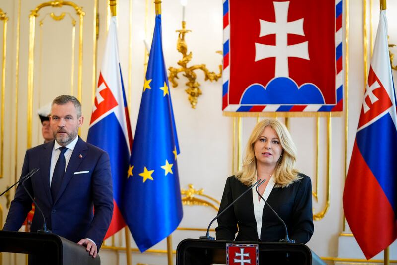 Slovakia’s incumbent President Zuzana Caputova, right, and President-elect Peter Pellegrini hold joint a press conference at the presidential palace in Bratislava (Petr David Josek/AP)
