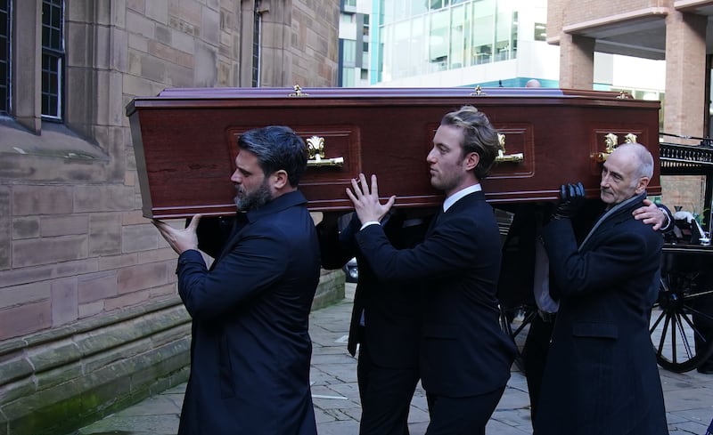 Pall bearers carry the coffin into the funeral for former Brookside actor Dean Sullivan