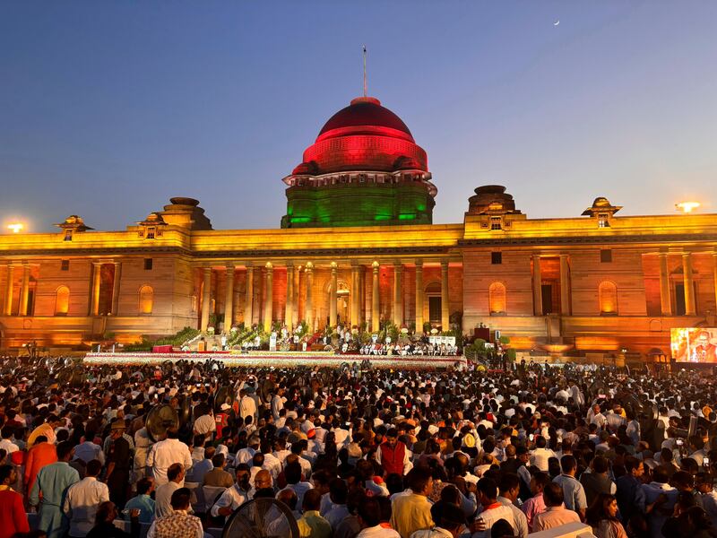 People watch as Narendra Modi is sworn-in as the prime minister of India by President Draupadi Murmu at the Rashtrapati Bhawan in New Delhi (Manish Swarup/AP)