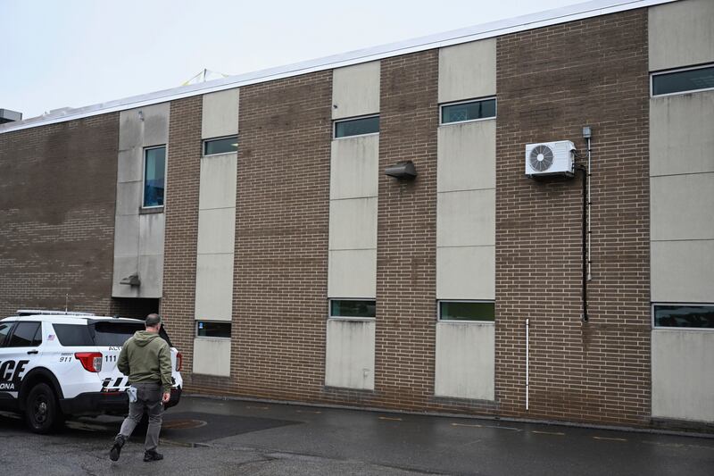 A law enforcement officer walks into the Altoona Police Department where 26-year old Luigi Mangione is being held (Benjamin B. Braun/Pittsburgh Post-Gazette via AP)