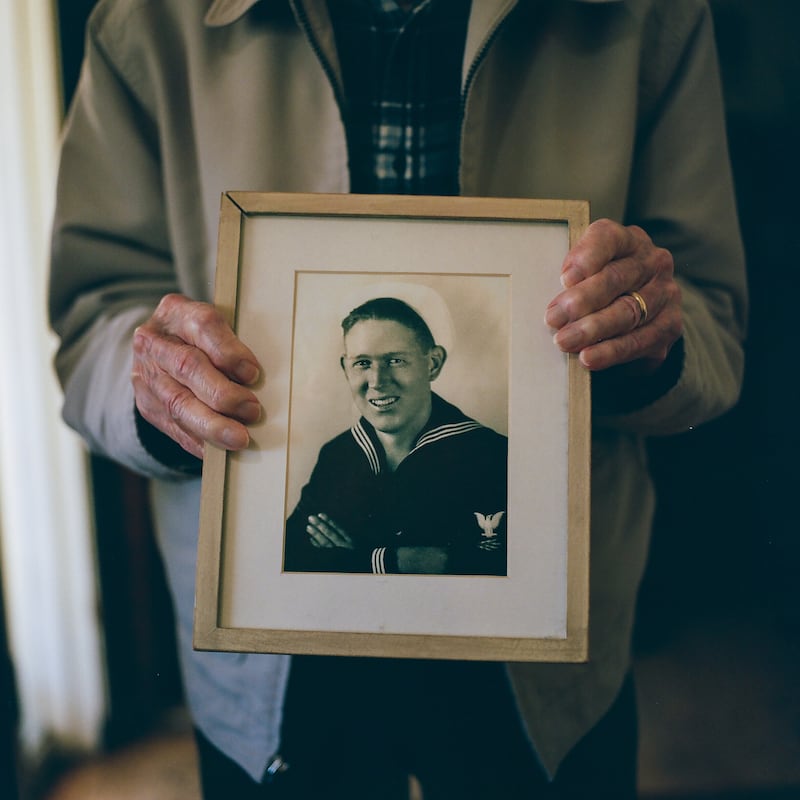 Warren Upton holds a picture of himself as a young serviceman (Shae Hammond/Bay Area News Group via AP)