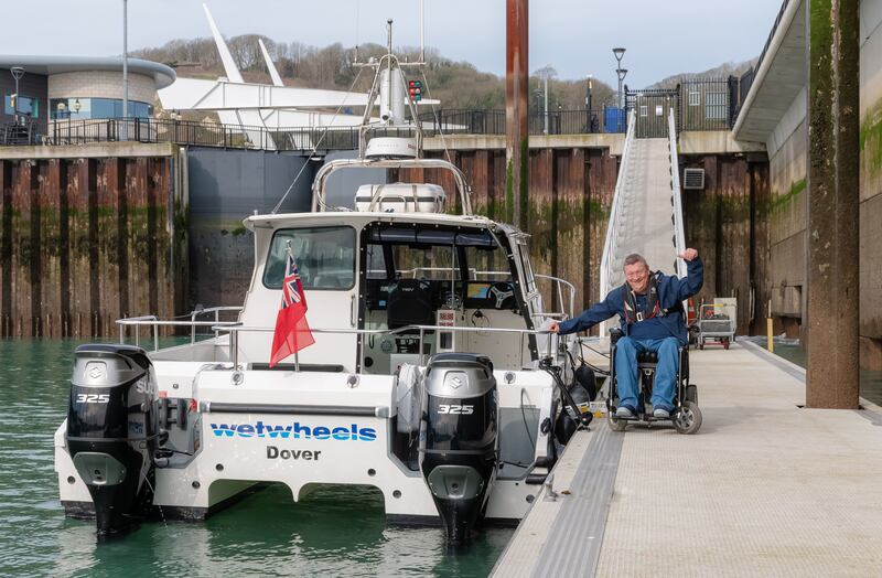 Mr Holt beside a Wetwheels boat