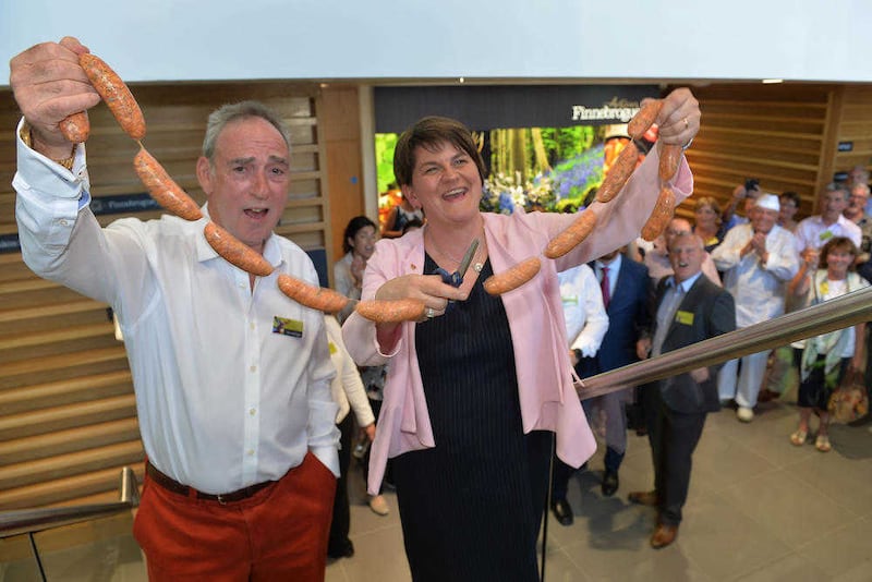 Finnebrogue&rsquo;s chairman Denis Lynn and First Minister Arlene Foster officially open the new &pound;25 million processing facility in Downpatrick by cutting a ribbon of sausages 