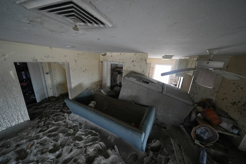 Several feet of sand fills a home following the passage of Hurricane Milton, at YCA Vacation Rentals in Venice, Florida (Rebecca Blackwell/AP)