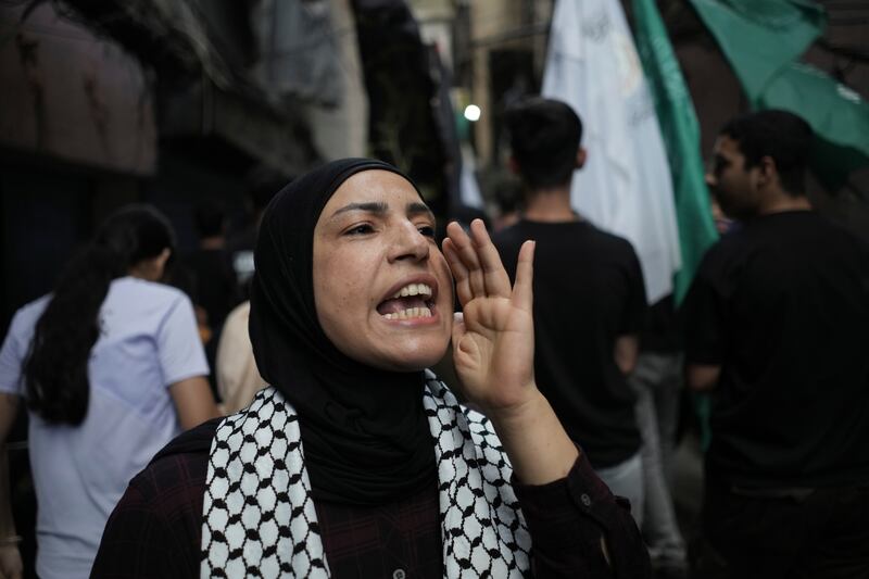 A Palestinian woman chants slogans against Israel during a protest at the Palestinian refugee camp of Chatila in Beirut, Lebanon (Hassan Ammar/AP)