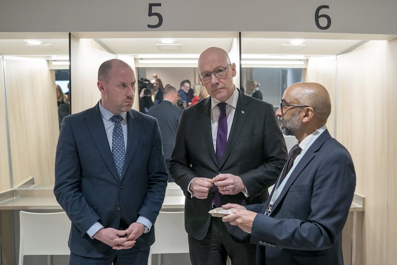 First Minister John Swinney, centre, and Health Secretary Neil Gray, left, with Dr Saket Priyadarshi at the centre