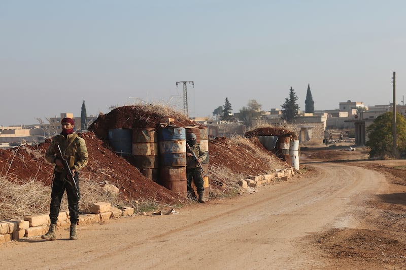 Syrian opposition fighters stand guard in Kafr Halab in the Aleppo countryside, Syria (Ghaith Alsayed/AP)