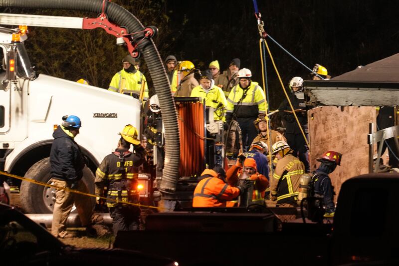 Rescue workers search in a sinkhole for Elizabeth Pollard (Gene J Puskar/AP)