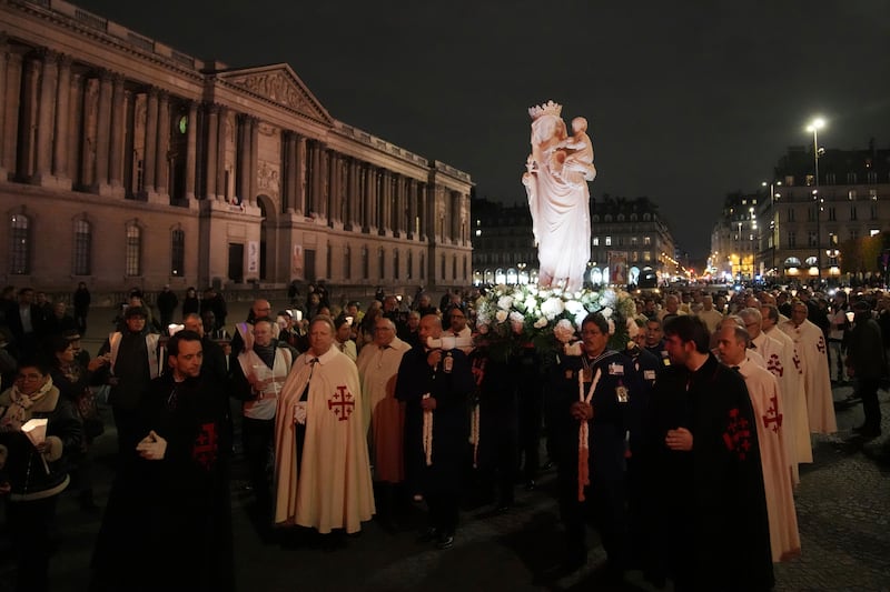 A replica of the Virgin Mary statue is carried from Saint-Germain l’Auxerrois church to Notre-Dame cathedral during a procession in Paris (Christophe Ena/AP)