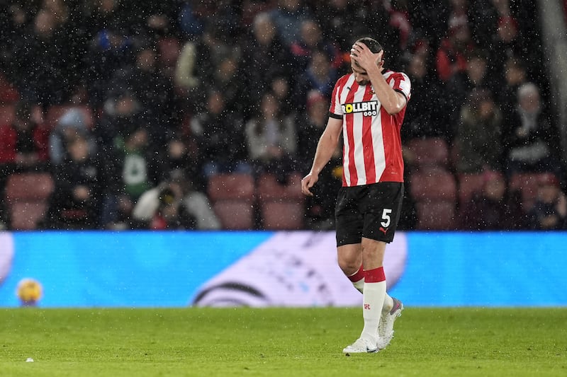 Jack Stephens leaves the pitch after being shown a red card