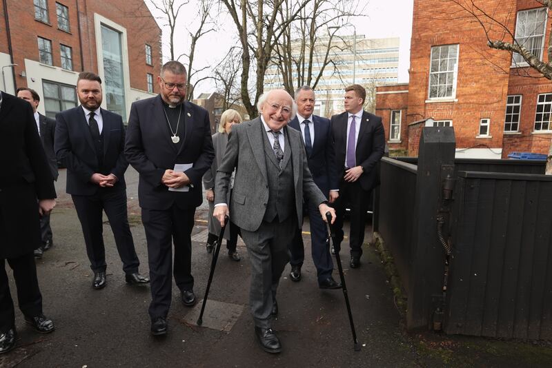 Irish President Michael D Higgins arrives for the funeral of poet Michael Longley