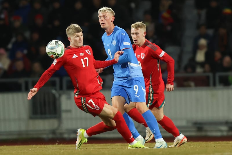 Wales midfielder Jordan James, left, challenges Iceland’s Orri Óskarsson in their 2-2 Nations League draw in Reykjavik (Arni Torfason/AP)