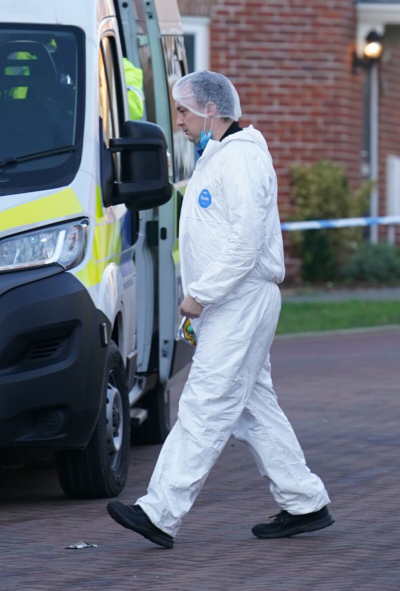 A forensic investigator outside a house in Costessey near Norwich