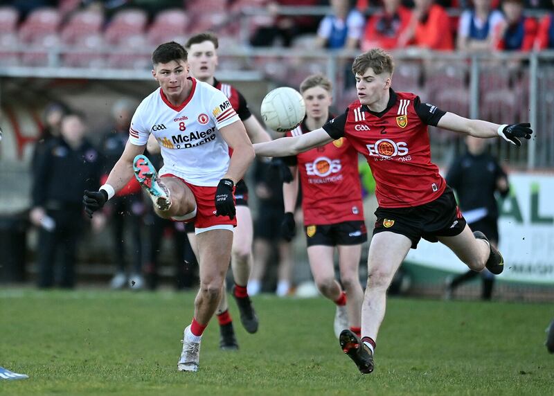 Tyrone's Ruairí McHugh gets a shot off despite pressure from Down's Patrick McCarthy.