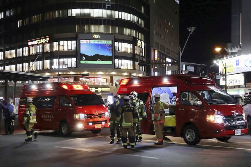 Paramedics attend the scene of a knife attack in front of Nagano Station in Nagano, Japan (Kyodo News via AP)