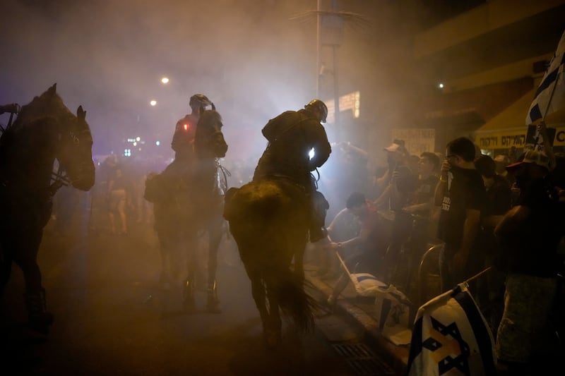 Israeli mounted police officers dispersed demonstrators blocking a road during a protest against Israeli Prime Minister Benjamin Netanyahu’s government (AP)