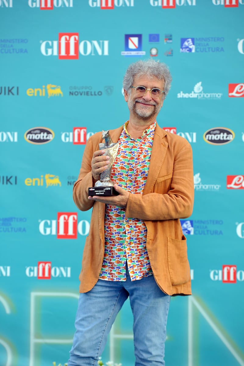 Italian director Enzo d'Alò picking up an award at Giffoni Film Festival for A Greyhound of a Girl